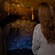 People inside a cave viewing stalactite formations